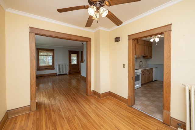 hall featuring baseboards, light wood-style floors, radiator heating unit, and crown molding