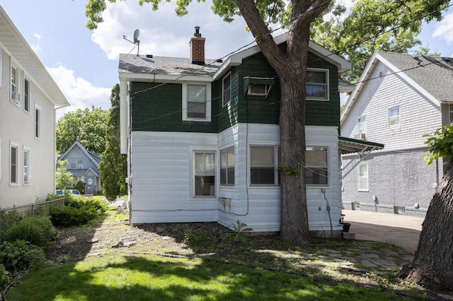 back of property featuring a patio and a chimney