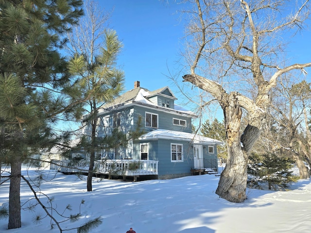 view of front of house featuring a deck and a chimney