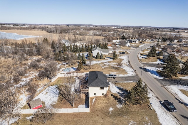 snowy aerial view with a residential view