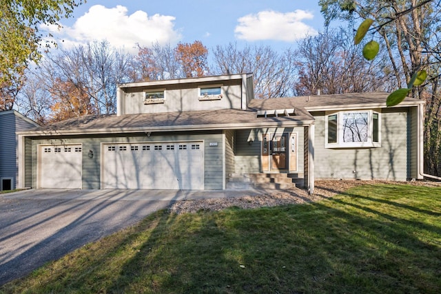 view of front of property with entry steps, driveway, and a front lawn