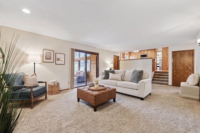 living area with stairway, carpet floors, and baseboards