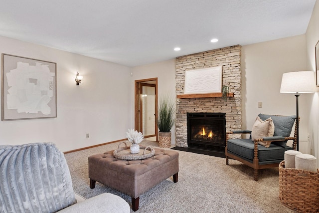 living room featuring a stone fireplace, recessed lighting, baseboards, and carpet