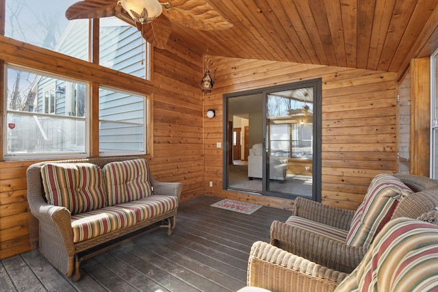 living room with wooden walls, wooden ceiling, wood-type flooring, and vaulted ceiling