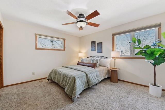 carpeted bedroom with a ceiling fan and baseboards