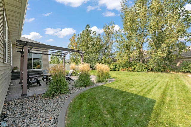 view of yard featuring a patio, fence, and a pergola