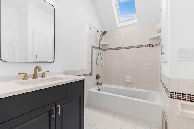 bathroom with a skylight, tile walls, shower / bathing tub combination, vanity, and tile patterned floors