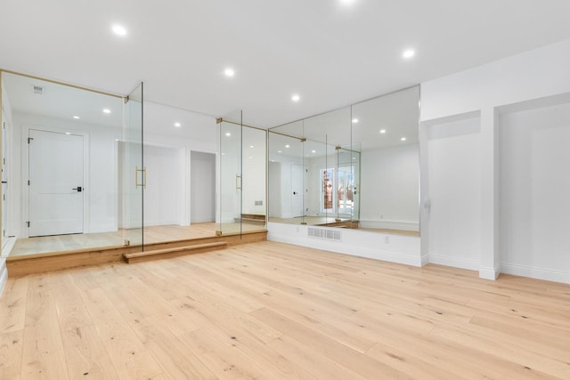 bathroom with baseboards, visible vents, wood finished floors, and recessed lighting