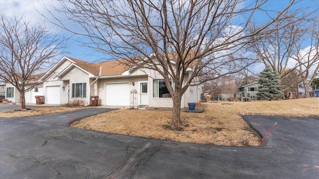 ranch-style house featuring driveway and an attached garage