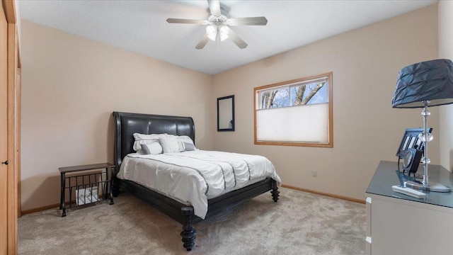 carpeted bedroom featuring ceiling fan and baseboards