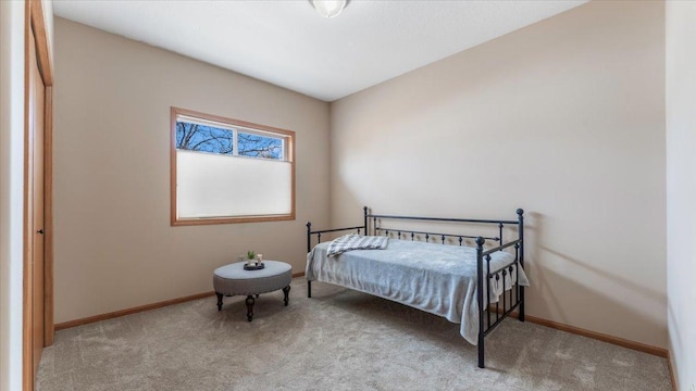 carpeted bedroom featuring baseboards