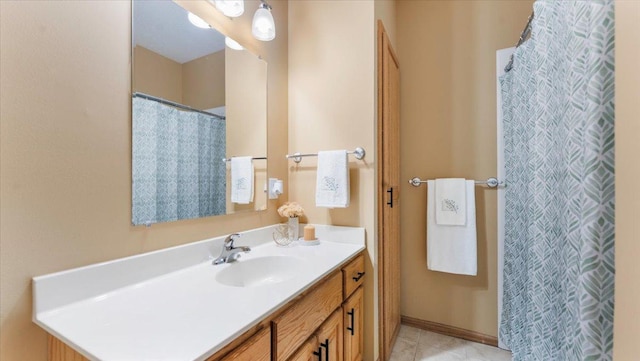 full bathroom featuring baseboards, a shower with curtain, vanity, and tile patterned floors