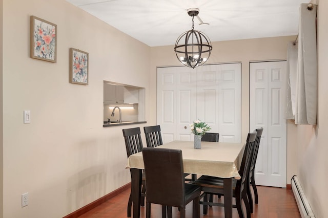 dining area featuring an inviting chandelier, dark wood-type flooring, baseboards, and baseboard heating