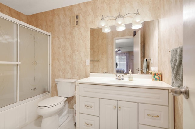 bathroom featuring tile patterned flooring, toilet, vanity, and shower / bath combination with glass door