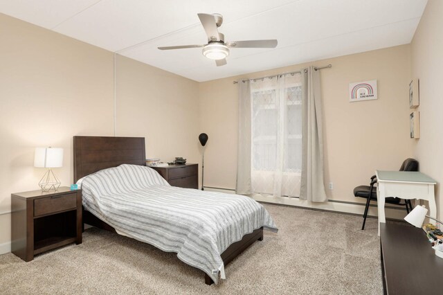 bedroom featuring a baseboard heating unit, a ceiling fan, and carpet floors