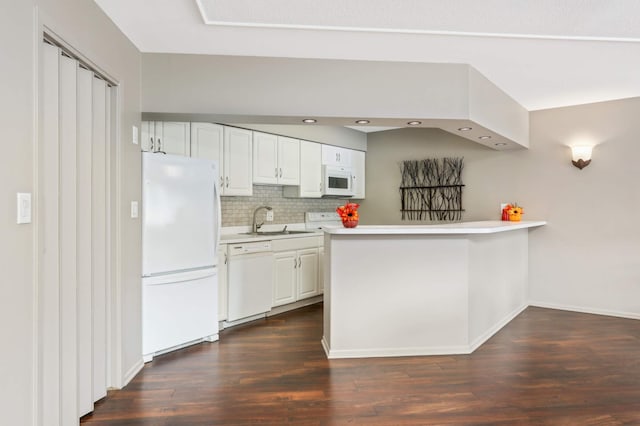 kitchen featuring a sink, backsplash, light countertops, white appliances, and dark wood-style flooring