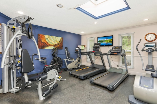 workout area with recessed lighting, baseboards, ornamental molding, and a skylight