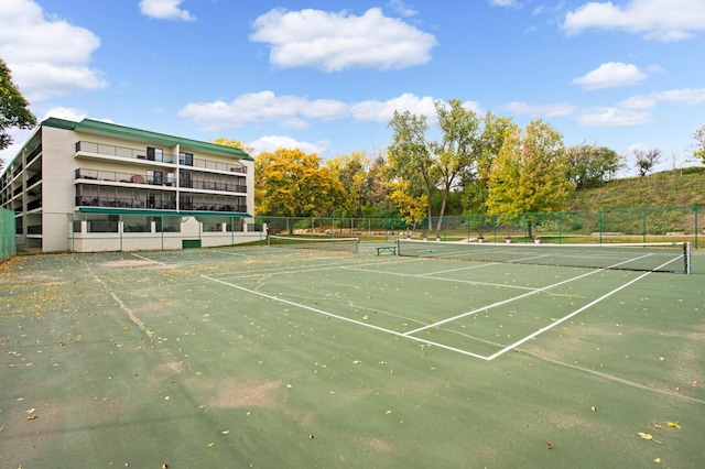 view of tennis court featuring fence