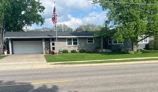 single story home with driveway, a garage, and a front yard