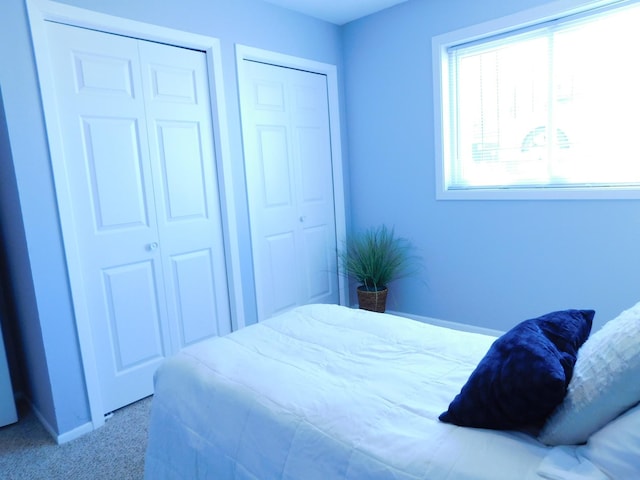 carpeted bedroom featuring baseboards