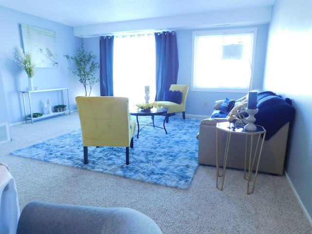 sitting room featuring carpet flooring and baseboards