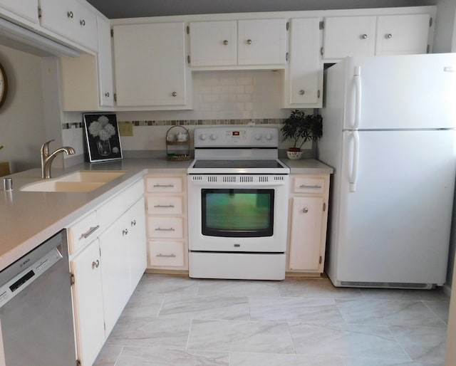 kitchen featuring white appliances, backsplash, light countertops, and a sink