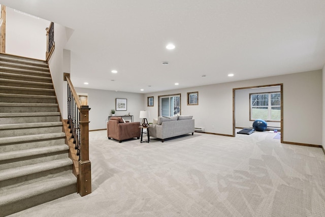 living room with light carpet, a baseboard heating unit, stairway, and recessed lighting