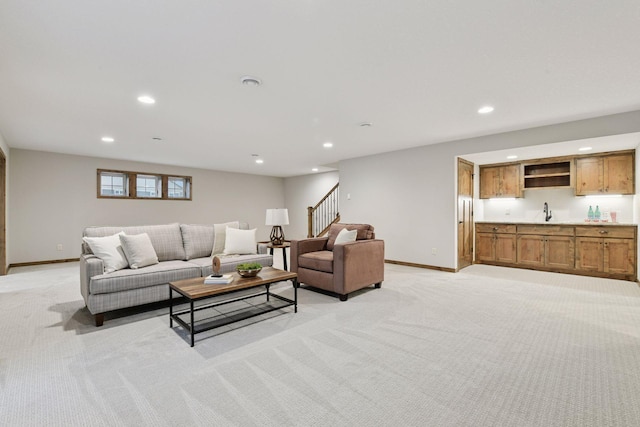 living room with recessed lighting, baseboards, and light colored carpet