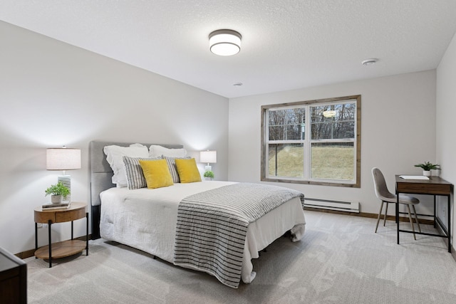 bedroom with a baseboard heating unit, carpet flooring, a textured ceiling, and baseboards