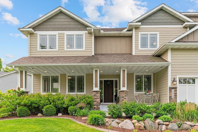 18928 Katrine Ct, Lakeville, MN 55044 - craftsman house with covered porch, a shingled roof, and board and batten siding