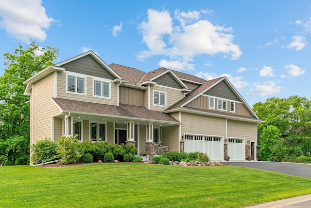 18928 Katrine Ct, Lakeville, MN 55044 - craftsman house with a porch, board and batten siding, roof with shingles, driveway, and a garage