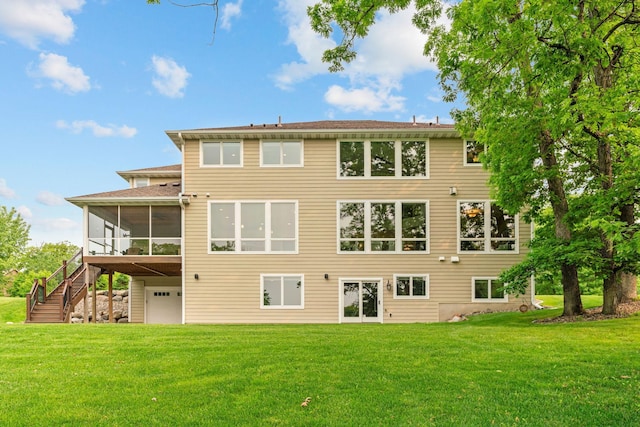 18928 Katrine Ct, Lakeville, MN 55044 - rear view of house featuring a sunroom, a yard, stairway, and a garage