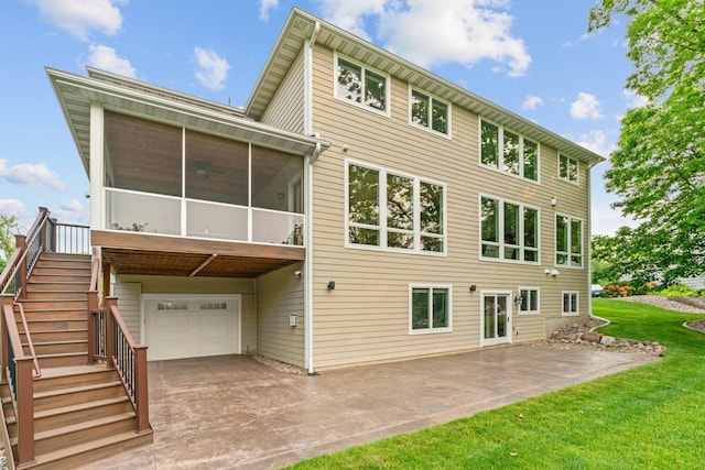 18928 Katrine Ct, Lakeville, MN 55044 - rear view of house featuring a garage, a sunroom, stairway, concrete driveway, and a yard