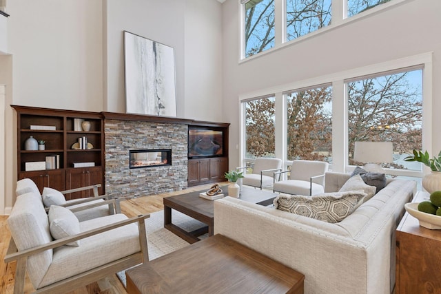 18928 Katrine Ct, Lakeville, MN 55044 - living room with a towering ceiling, wood finished floors, and a fireplace