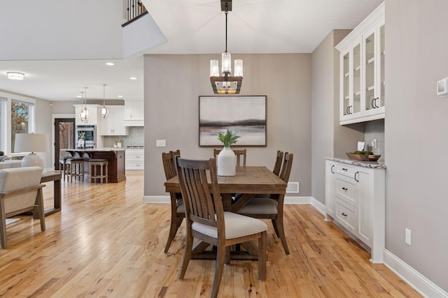 18928 Katrine Ct, Lakeville, MN 55044 - dining room with a chandelier, light wood-style floors, baseboards, and recessed lighting