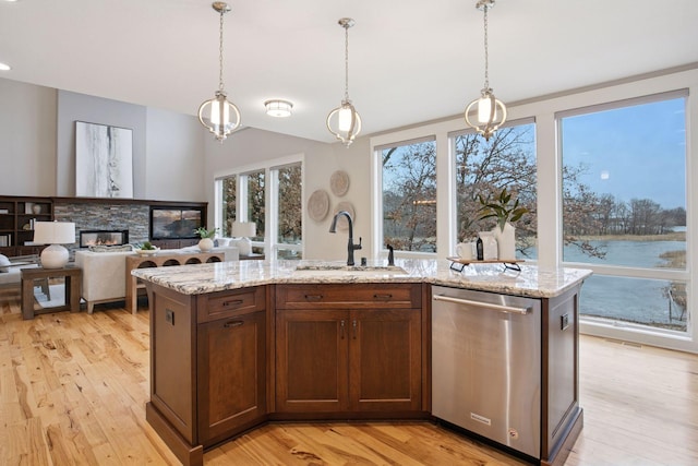 18928 Katrine Ct, Lakeville, MN 55044 - kitchen featuring dishwasher, a sink, light wood-style flooring, hanging light fixtures, and light stone counters