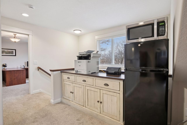 18928 Katrine Ct, Lakeville, MN 55044 - kitchen with freestanding refrigerator, stainless steel microwave, dark countertops, light carpet, and baseboards