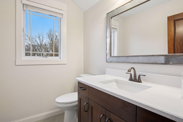 18928 Katrine Ct, Lakeville, MN 55044 - bathroom featuring vanity, toilet, tile patterned flooring, baseboards, and vaulted ceiling