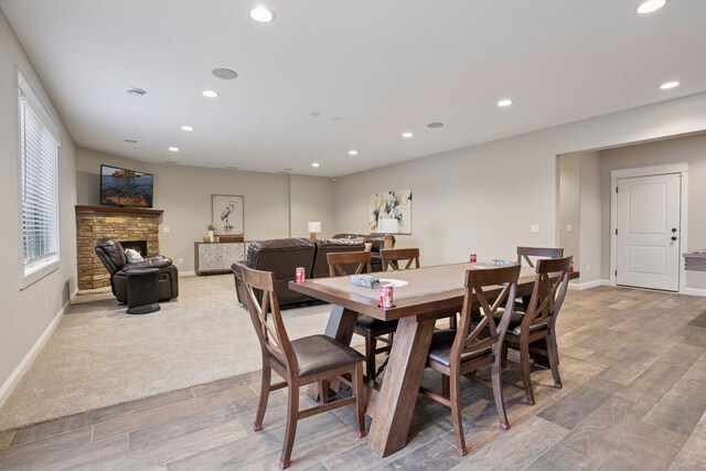 18928 Katrine Ct, Lakeville, MN 55044 - dining space with baseboards, recessed lighting, light wood-style floors, and a stone fireplace