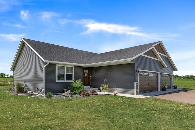 single story home with a front lawn, a garage, driveway, and a shingled roof