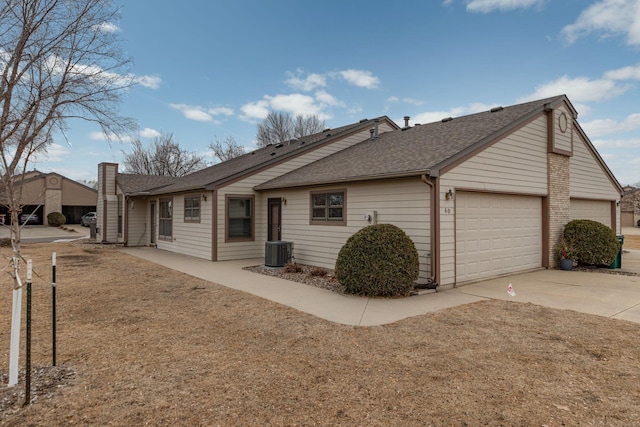 exterior space with a shingled roof, central AC, driveway, and a garage