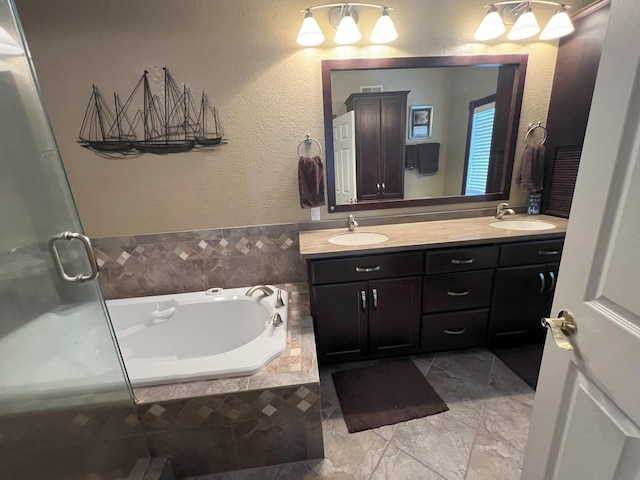 bathroom featuring a stall shower, a garden tub, a sink, and double vanity