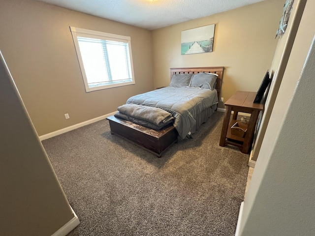 carpeted bedroom featuring baseboards