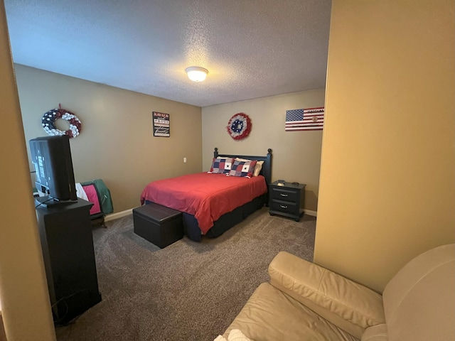 bedroom with a textured ceiling, carpet, and baseboards