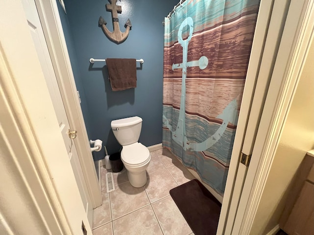 full bath with curtained shower, tile patterned flooring, toilet, and baseboards