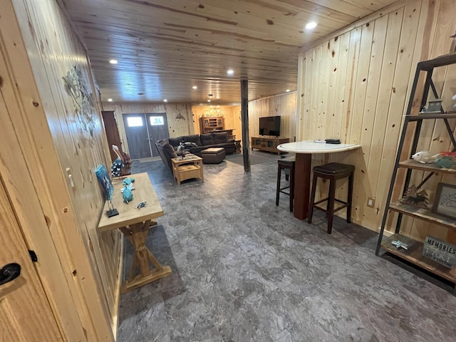 interior space with wood walls, wood ceiling, and recessed lighting