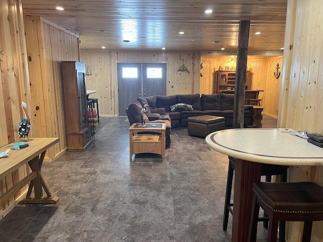 living room with wood walls, wooden ceiling, and recessed lighting