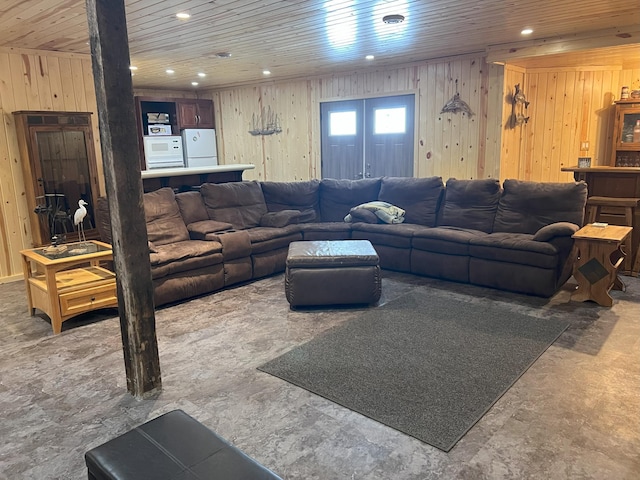 living area with wood ceiling, wooden walls, and recessed lighting