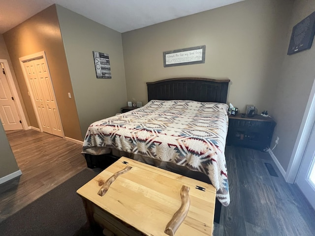 bedroom with baseboards and wood finished floors