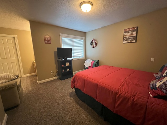 bedroom featuring a textured ceiling, baseboards, and carpet flooring